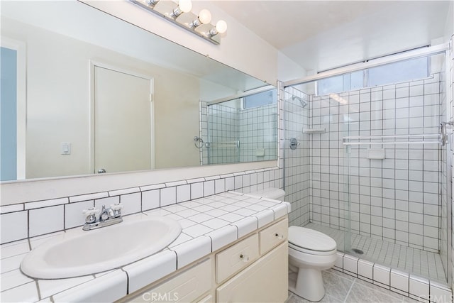 3899 28th St, Highland, CA 92346 - bathroom with a shower stall, toilet, vanity, tile walls, and decorative backsplash