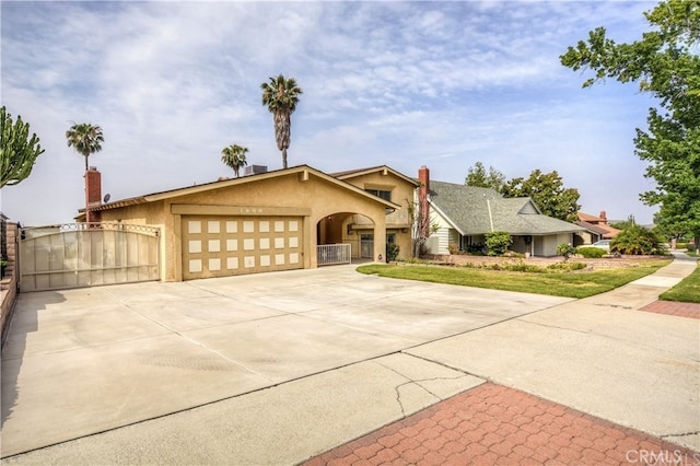 3899 28th St, Highland, CA 92346 - view of front facade featuring a garage, stucco siding, concrete driveway, and a gate