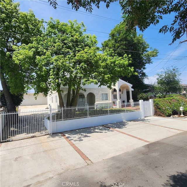6115 Vera St, Riverside, CA 92504 - view of property hidden behind natural elements with stucco siding and a fenced front yard