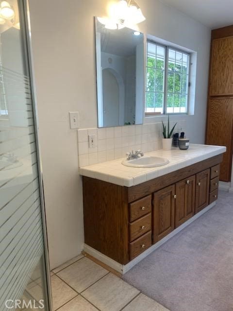 6115 Vera St, Riverside, CA 92504 - bathroom featuring vanity, decorative backsplash, and tile patterned floors