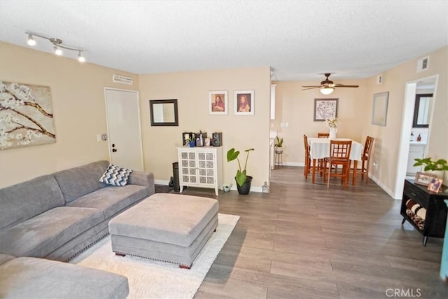 31732 Ridge Route Rd Unit 111, Castaic, CA 91384 - living area with a ceiling fan, wood finished floors, a textured ceiling, and baseboards