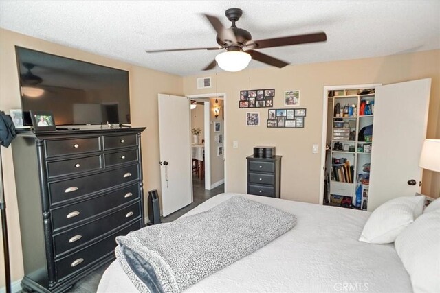 bedroom featuring ceiling fan, visible vents, a spacious closet, and a closet