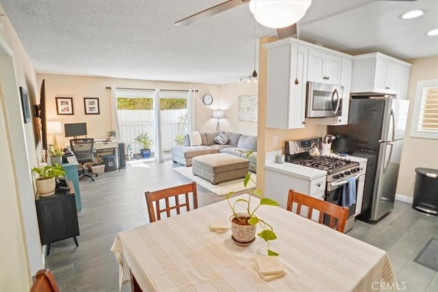 31732 Ridge Route Rd Unit 111, Castaic, CA 91384 - dining space with light wood finished floors, an office area, a ceiling fan, and a textured ceiling