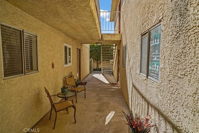 view of property exterior featuring stucco siding and stairway