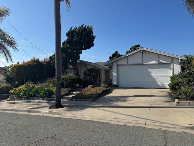 view of front of house featuring stucco siding and concrete driveway