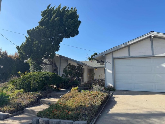 ranch-style house with concrete driveway