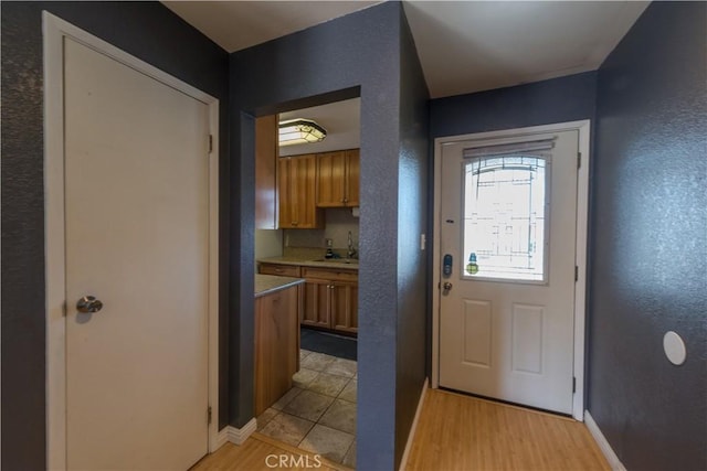 538 Milky Way, Vandenberg Village, CA 93436 - doorway with a textured wall, baseboards, and light wood-type flooring