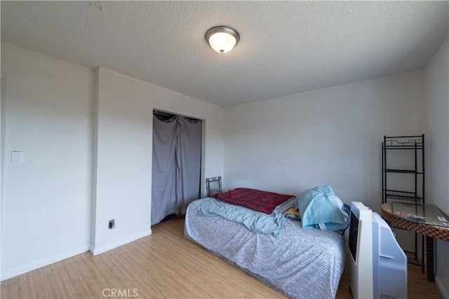 538 Milky Way, Vandenberg Village, CA 93436 - bedroom featuring a textured ceiling, baseboards, and wood finished floors