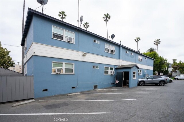 4325 Clinton St, Los Angeles, CA 90004 - back of property featuring stucco siding, cooling unit, uncovered parking, and crawl space