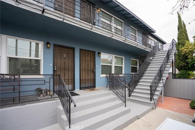 4325 Clinton St, Los Angeles, CA 90004 - view of exterior entry with a patio, fence, and stucco siding