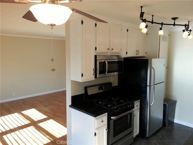 4325 Clinton St, Los Angeles, CA 90004 - kitchen with crown molding, dark countertops, stainless steel appliances, and white cabinetry