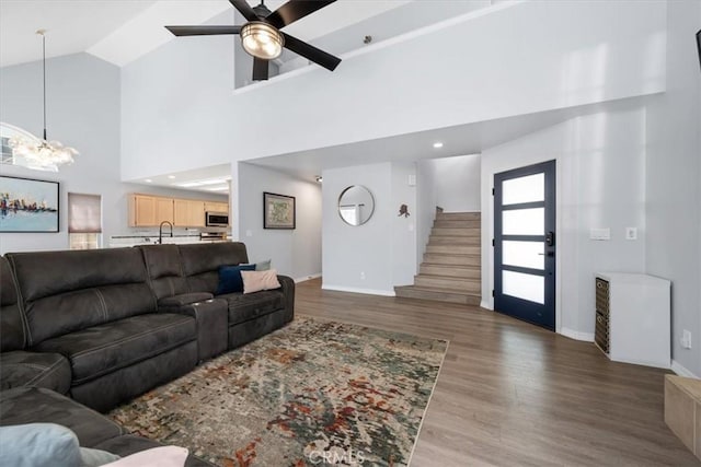 317 Alder St, Arroyo Grande, CA 93420 - living area featuring baseboards, ceiling fan with notable chandelier, high vaulted ceiling, and wood finished floors