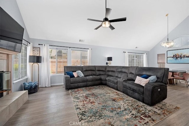 317 Alder St, Arroyo Grande, CA 93420 - living area with high vaulted ceiling, ceiling fan with notable chandelier, wood finished floors, and visible vents