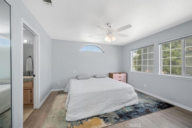 317 Alder St, Arroyo Grande, CA 93420 - bedroom with visible vents, wood finished floors, baseboards, connected bathroom, and a ceiling fan