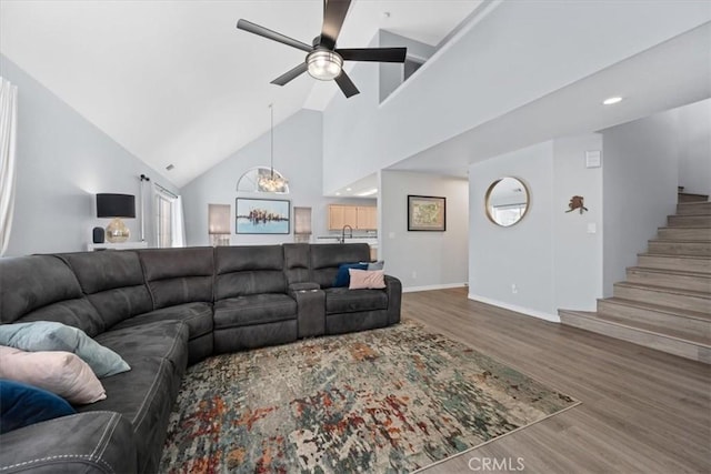 317 Alder St, Arroyo Grande, CA 93420 - living room featuring high vaulted ceiling, ceiling fan with notable chandelier, baseboards, wood finished floors, and stairway