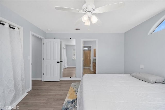 317 Alder St, Arroyo Grande, CA 93420 - bedroom with baseboards, visible vents, wood finished floors, and connected bathroom