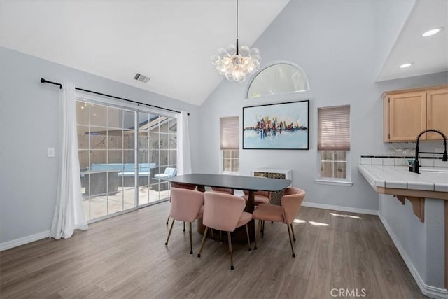 317 Alder St, Arroyo Grande, CA 93420 - dining room with baseboards, a notable chandelier, wood finished floors, and visible vents