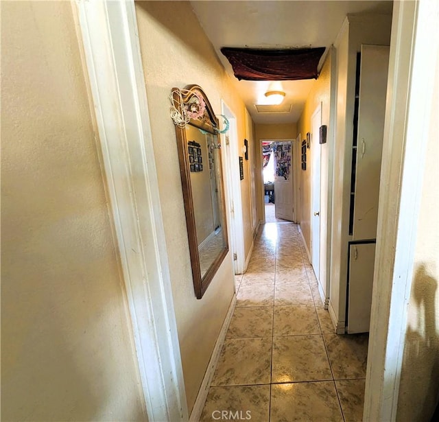 14136 Osage Rd, Apple Valley, CA 92307 - corridor with a textured wall, baseboards, and light tile patterned floors
