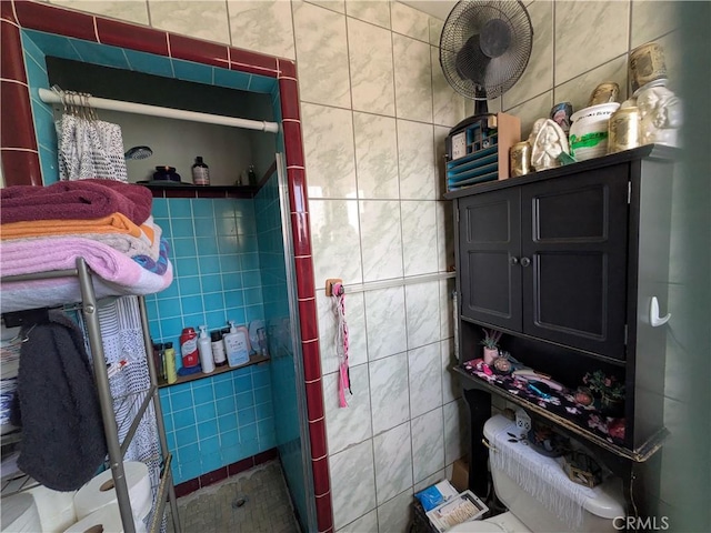 14136 Osage Rd, Apple Valley, CA 92307 - bathroom featuring a stall shower and tile walls