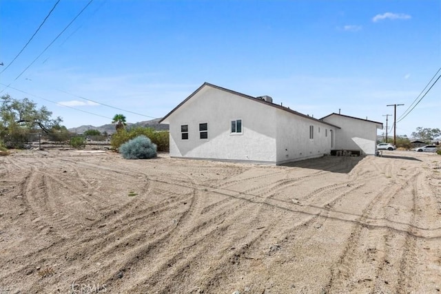 view of side of property with stucco siding