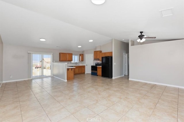 unfurnished living room with a sink, baseboards, ceiling fan, and vaulted ceiling