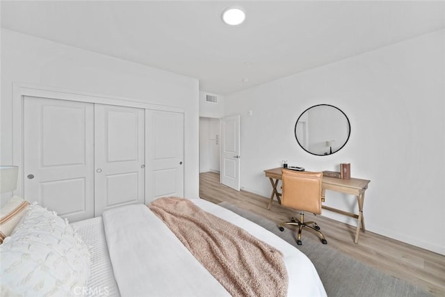 2475 Victoria Ave Unit 410, San Luis Obispo, CA 93401 - bedroom with a closet, visible vents, wood finished floors, and baseboards