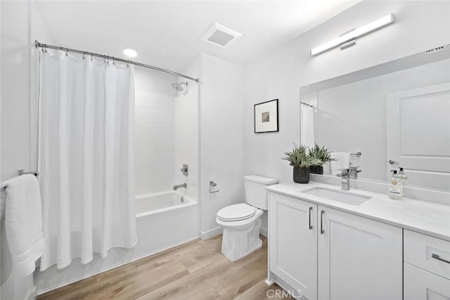 2475 Victoria Ave Unit 410, San Luis Obispo, CA 93401 - full bath with toilet, wood finished floors, shower / tub combo with curtain, visible vents, and vanity