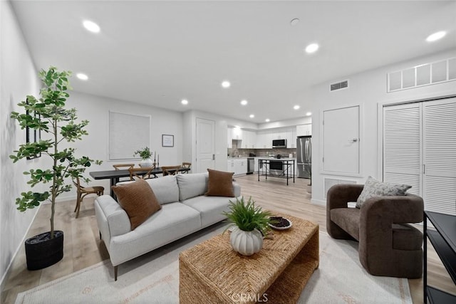 2475 Victoria Ave Unit 410, San Luis Obispo, CA 93401 - living area featuring recessed lighting, light wood finished floors, and visible vents