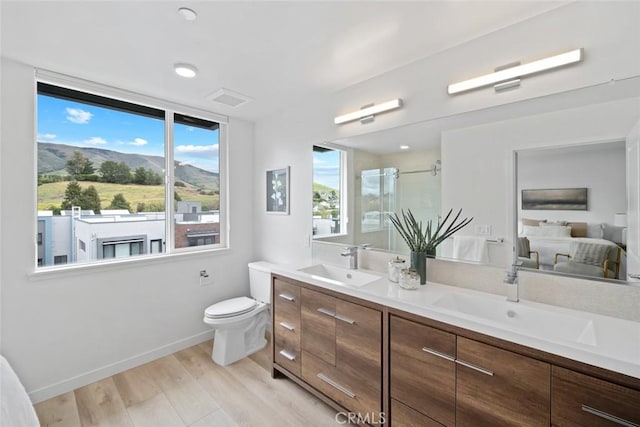 2475 Victoria Ave Unit 410, San Luis Obispo, CA 93401 - ensuite bathroom featuring double vanity, wood finished floors, a stall shower, and a sink