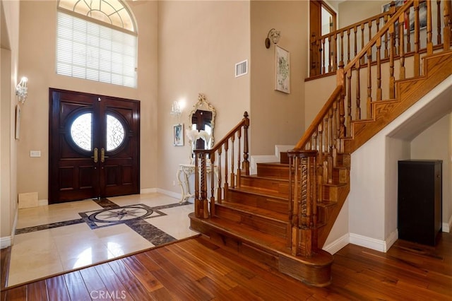 20454 Sartell Dr, Walnut, CA 91789 - entrance foyer with plenty of natural light, a towering ceiling, visible vents, baseboards, and stairs