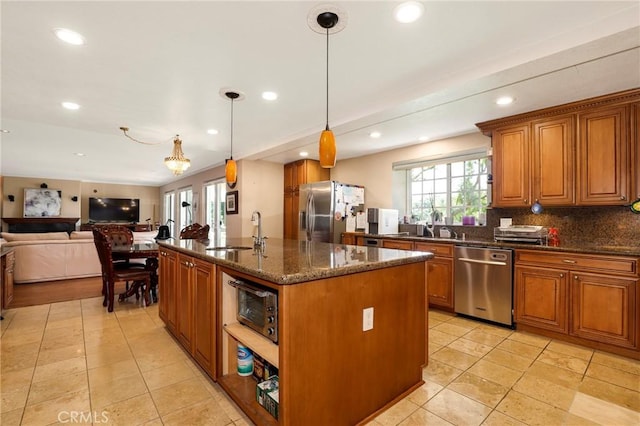 20454 Sartell Dr, Walnut, CA 91789 - kitchen featuring a kitchen island with sink, open floor plan, brown cabinets, a sink, and stainless steel appliances