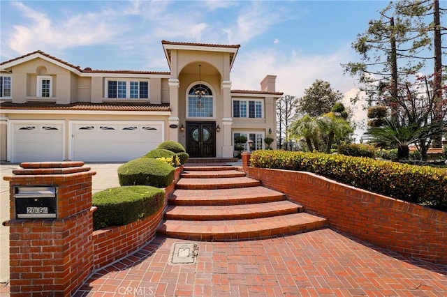 20454 Sartell Dr, Walnut, CA 91789 - mediterranean / spanish house with stucco siding, a chimney, concrete driveway, an attached garage, and a tile roof