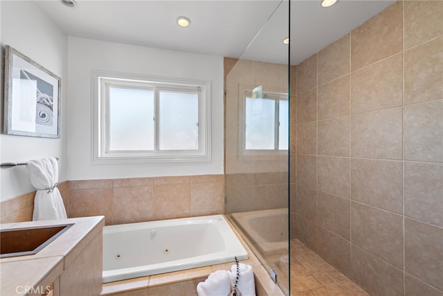 bathroom with a jetted tub, walk in shower, and recessed lighting