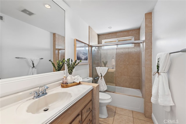 full bath featuring tile patterned flooring, vanity, toilet, visible vents, and bath / shower combo with glass door
