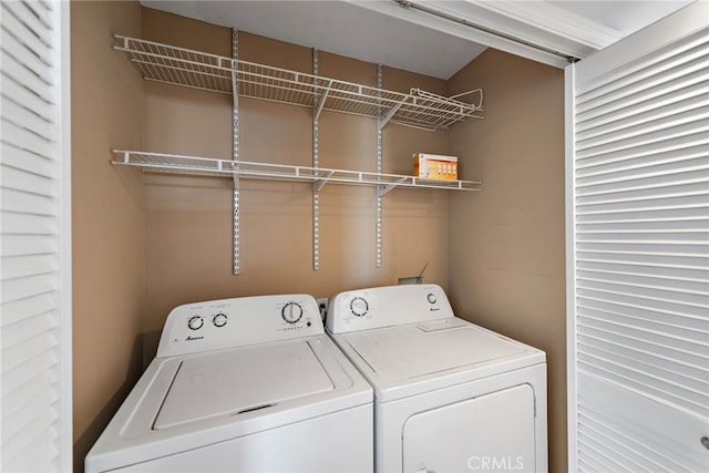 washroom with separate washer and dryer and laundry area