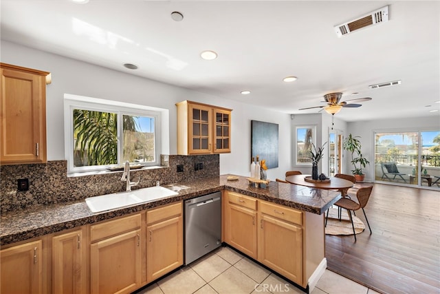 kitchen with visible vents, a sink, dishwasher, and a healthy amount of sunlight