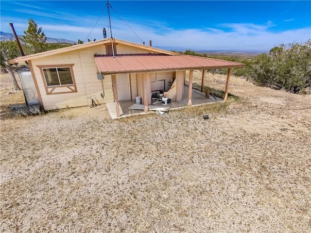 30711 212nd St E, Llano, CA 93544 - rear view of house with a patio area, a mountain view, and metal roof
