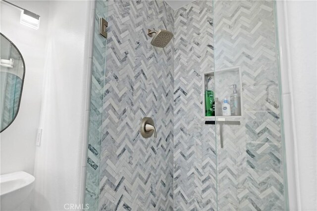 bathroom with tiled shower