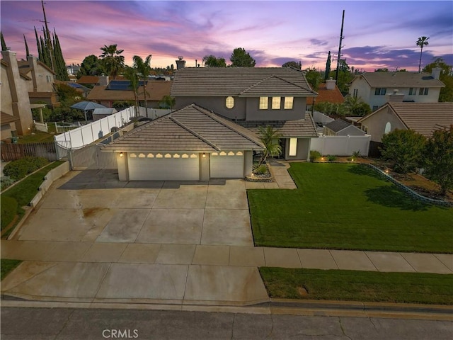traditional-style home with fence, an attached garage, stucco siding, concrete driveway, and a tiled roof