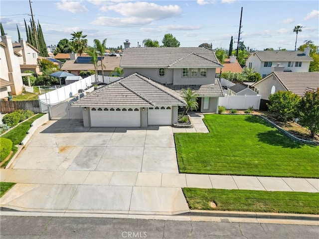 traditional-style house with fence, a tiled roof, an attached garage, driveway, and a residential view