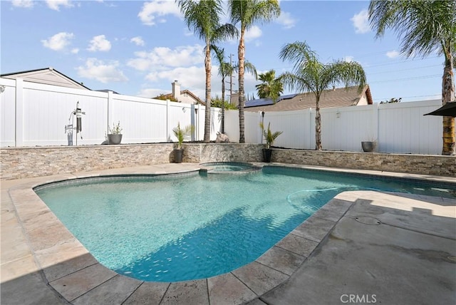 view of pool featuring a patio, a fenced backyard, and a pool with connected hot tub