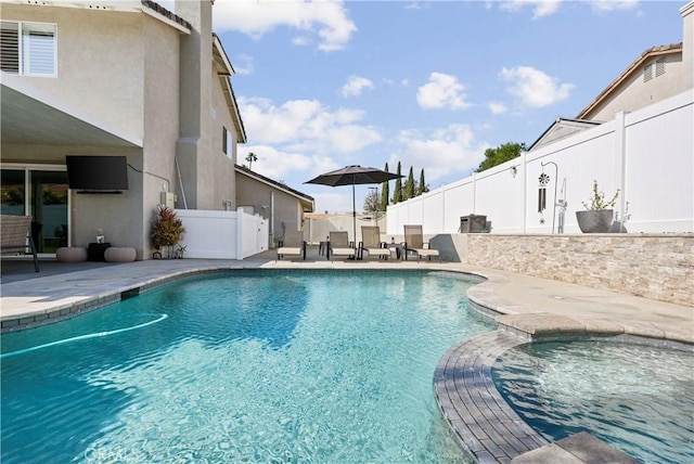 view of pool with a patio, a pool with connected hot tub, and a fenced backyard