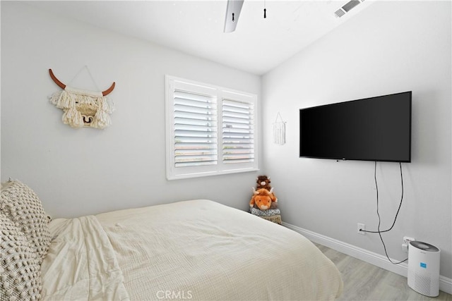 bedroom with visible vents, baseboards, ceiling fan, and wood finished floors