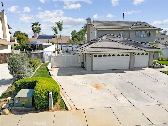 traditional home with fence, a garage, stucco siding, a gate, and driveway
