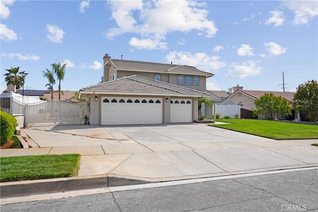 traditional-style house with a front yard, stucco siding, a gate, an attached garage, and driveway