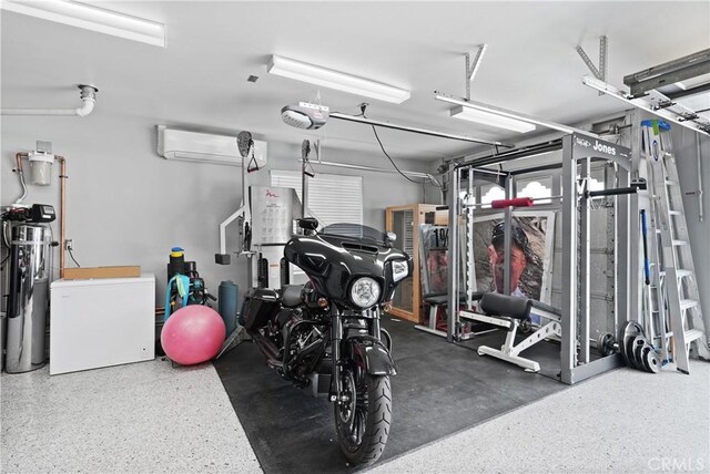 gym with a garage and a wall unit AC