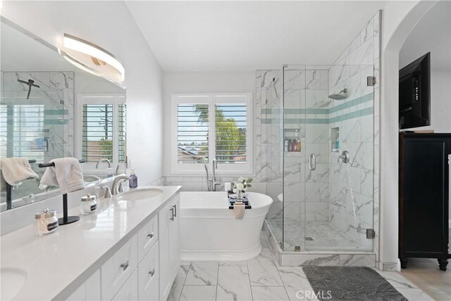 full bath featuring a sink, a shower stall, marble finish floor, and a wealth of natural light