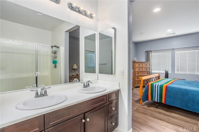1229 Pinehurst Dr, Calimesa, CA 92320 - bathroom with wood finished floors, a shower stall, double vanity, recessed lighting, and ensuite bath