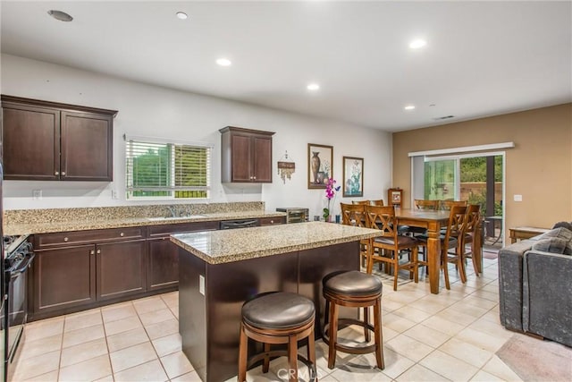 1229 Pinehurst Dr, Calimesa, CA 92320 - kitchen featuring black range with gas cooktop, light tile patterned floors, a center island, dark brown cabinets, and recessed lighting