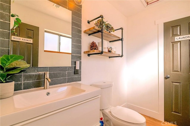half bathroom featuring vanity and toilet